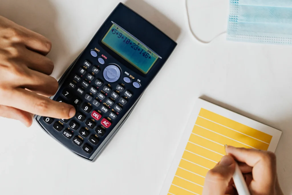 A man using calculator to count his monthly income