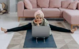 women doing yoga in front of laptop